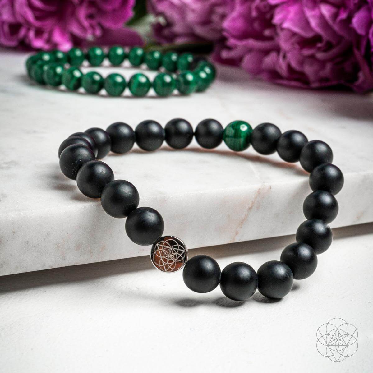 Steady Mind - Malachite & Onyx Double Bracelet, black onyx bracelet with stainless steel logo charm on marble