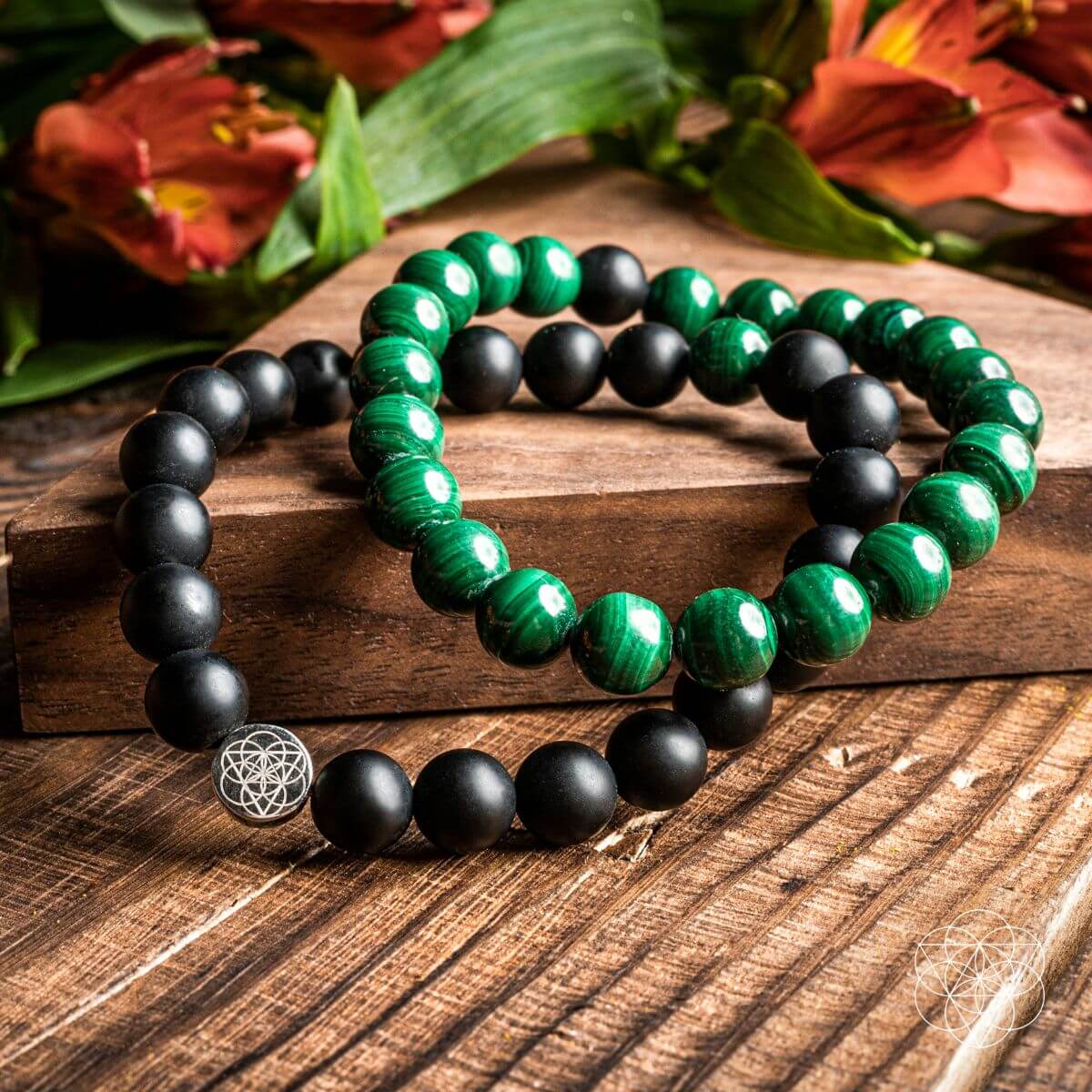 Steady Mind - Malachite &amp; Onyx Double Bracelet, both bracelets on a wooden board with flowers